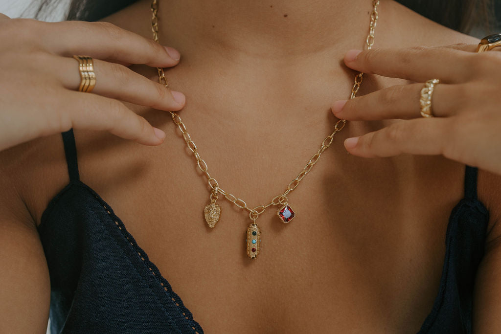 charm necklace. gold, strength capsule, Lion Charm & Ruby Gem with rings. Olive James. 